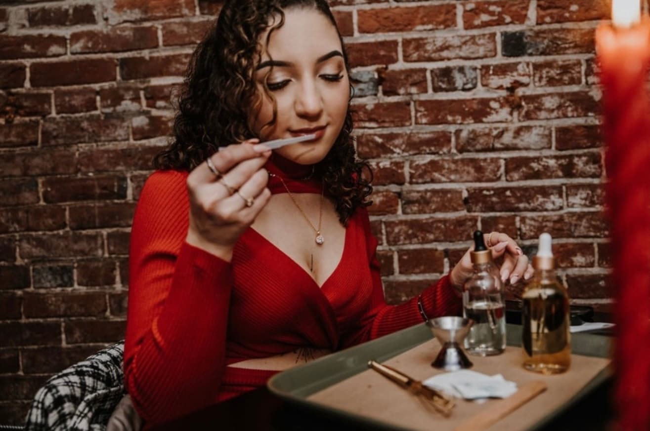 A guest sampling a scent at the Wax + Wine bar