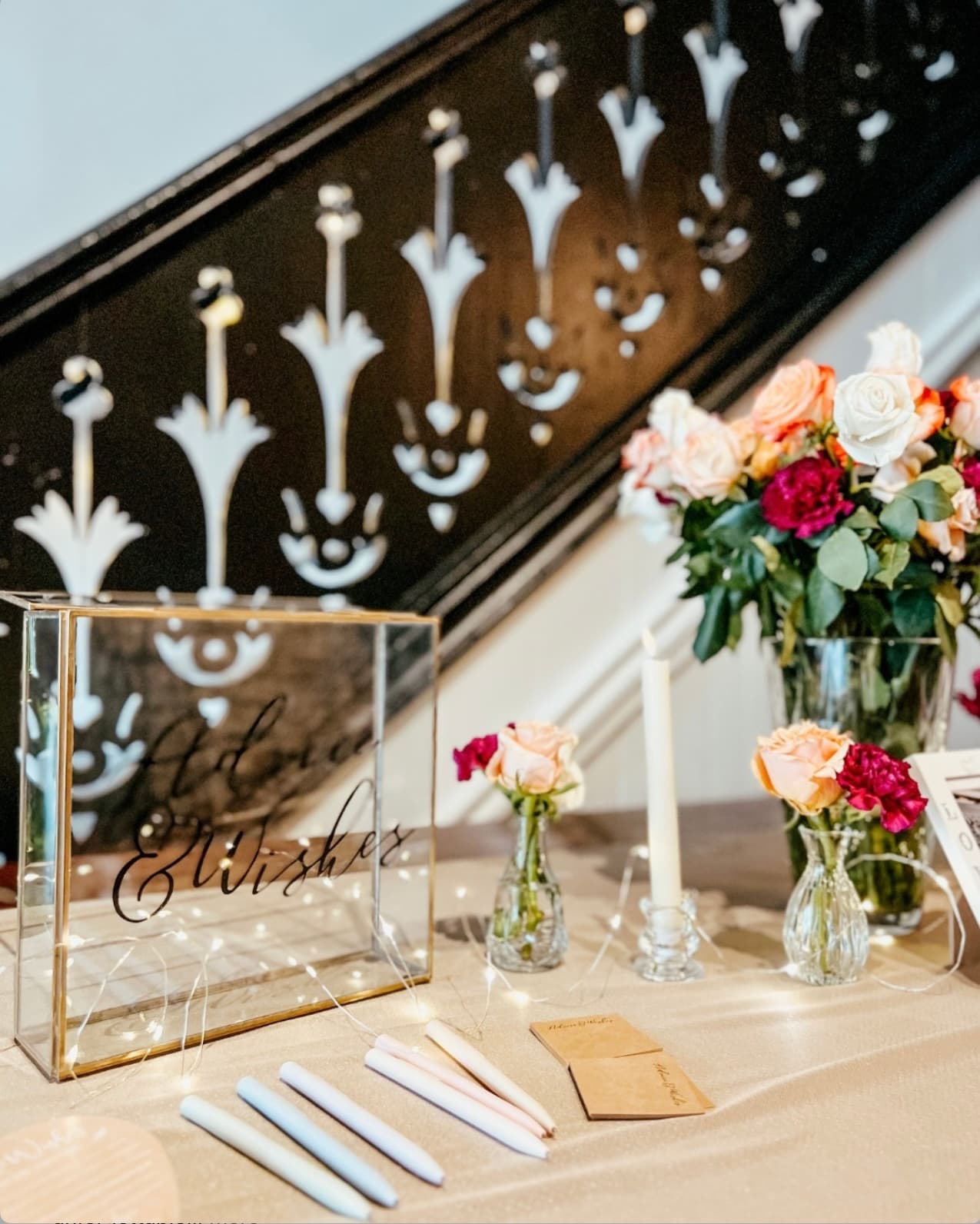 A private event table set with candles, roses, and champagne at Wax + Wine