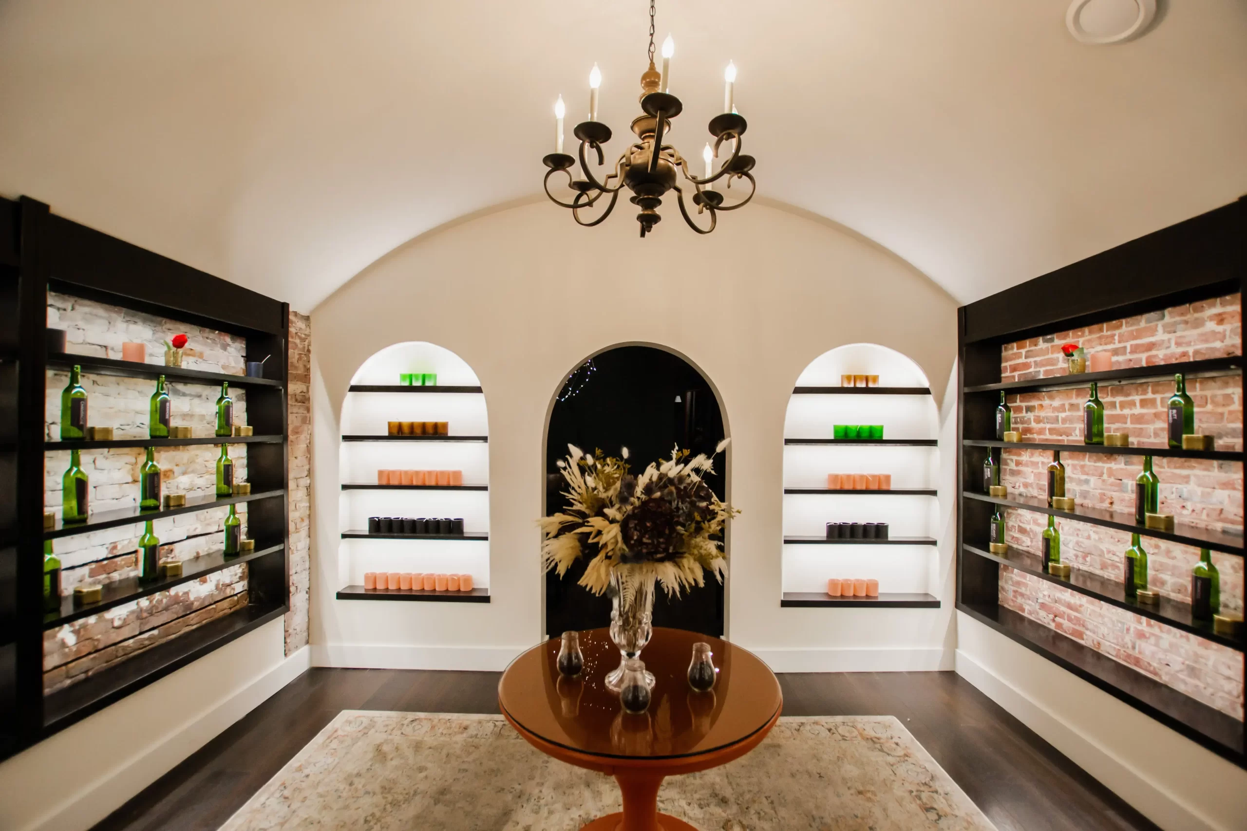 The Wax + Wine scent cellar with bottle-lined arched alcoves in Old City Philadelphia