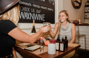 woman drinking wine at wax and wine